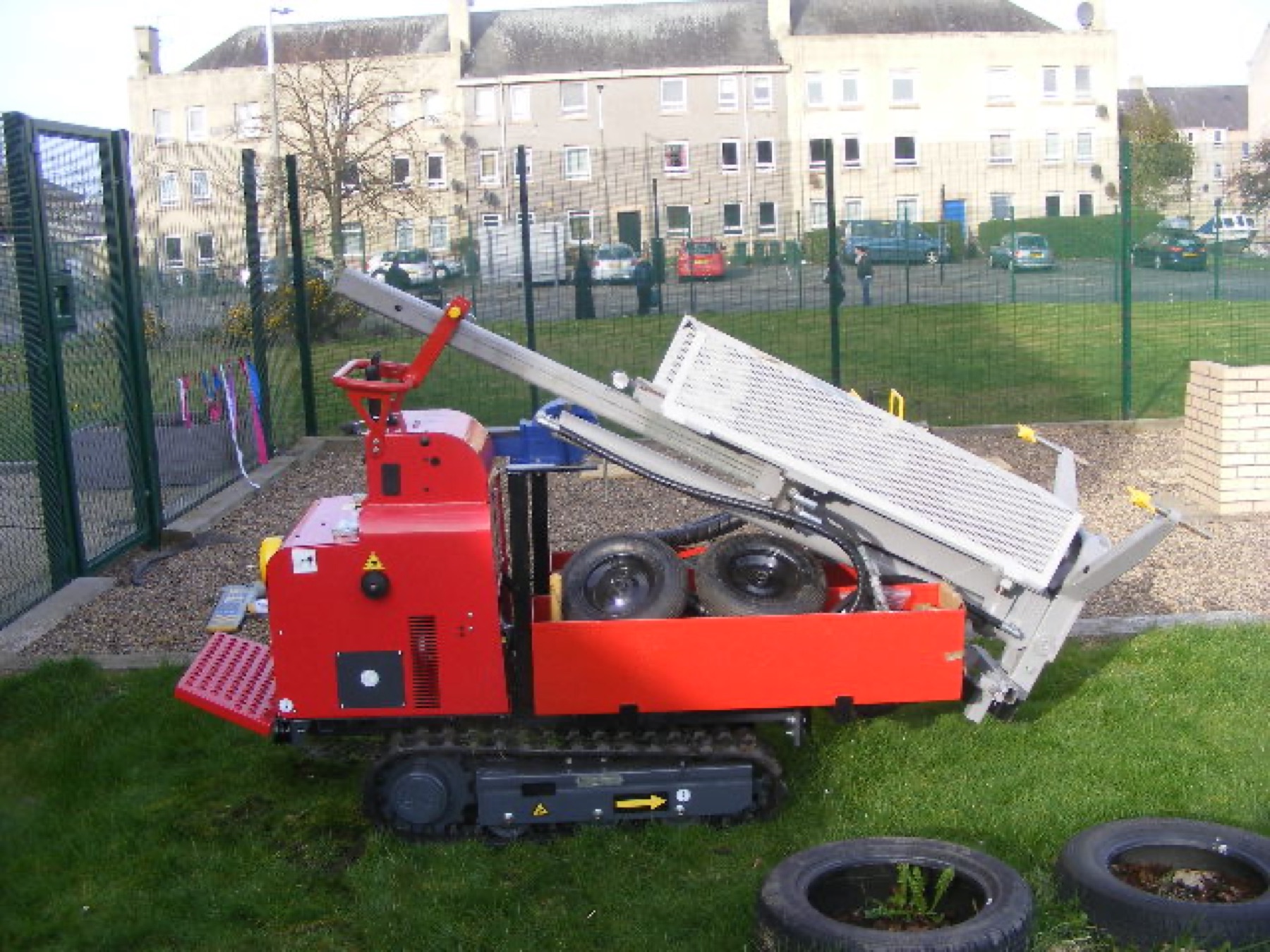 A tracked site investigation rig standing on open grass.
