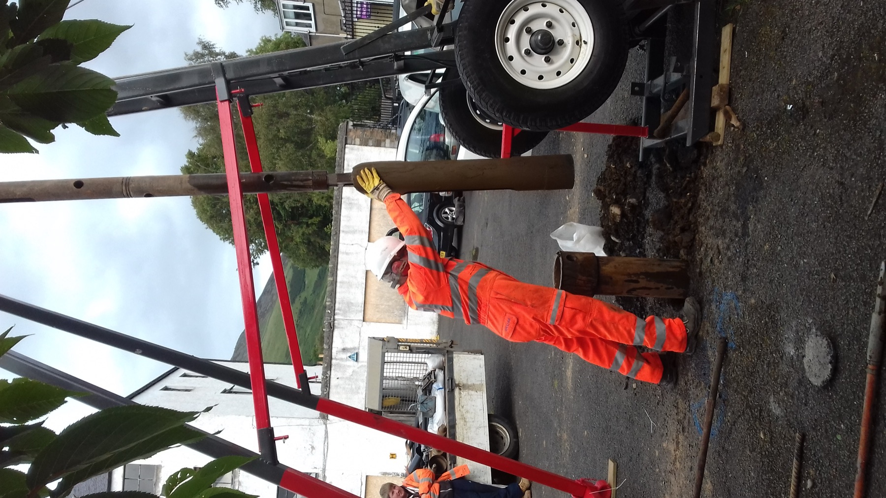 A cable percussion drilling rig set up over a borehole.